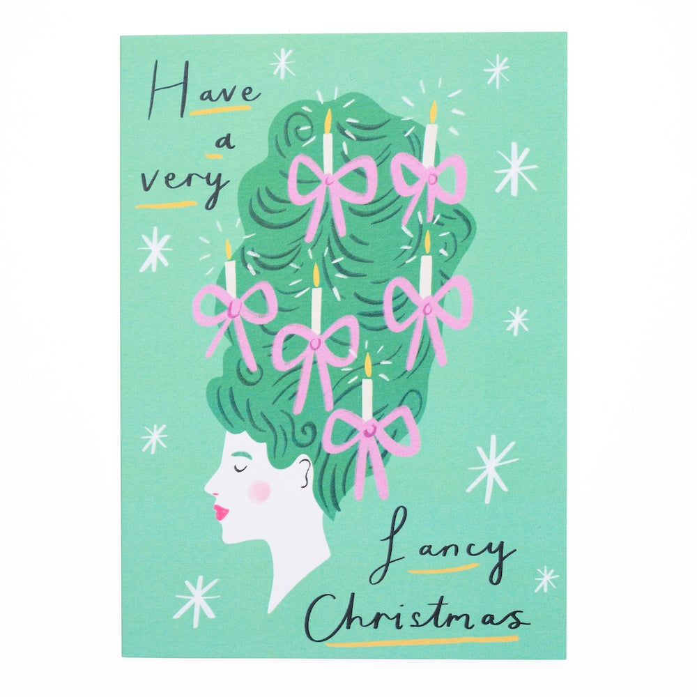 Christmas themed greeting card with a woman with tall green hair, pink bows, and candles on a light green background with the text 'have a very fancy christmas'.