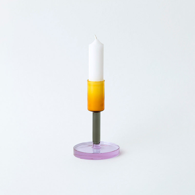 Glass candlestick holder in orange, grey and purple block colour sections.