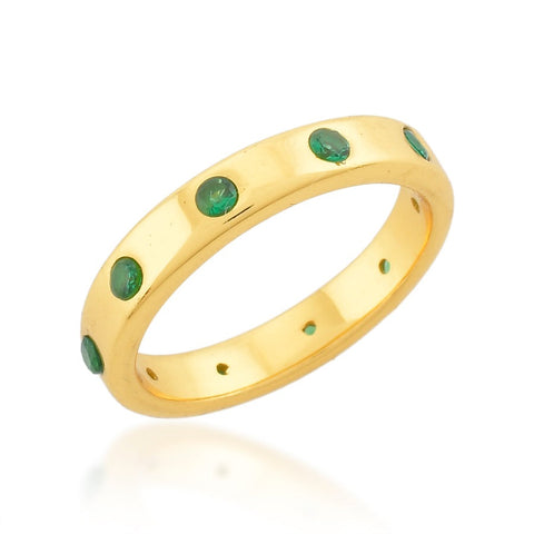 A gold ring with green crystals.