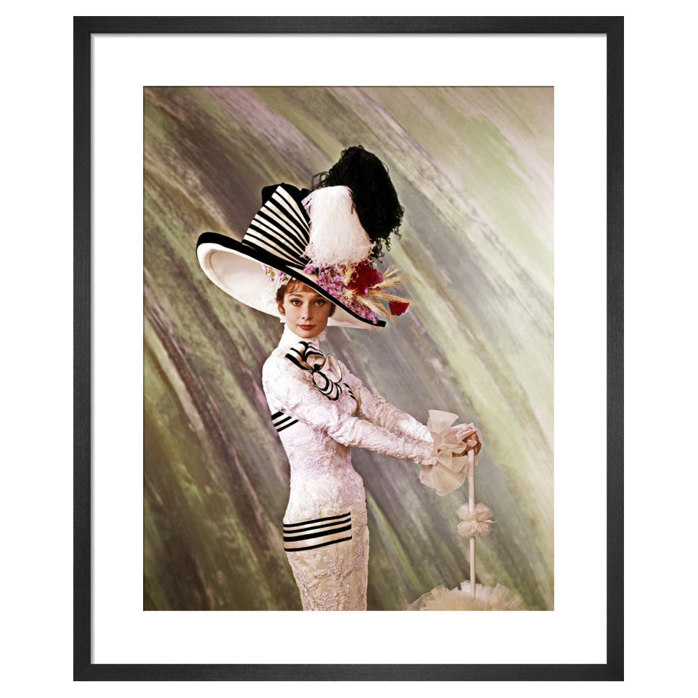 Framed vintage style photograph of a woman in a white dress with black stripes and a large decorative hat.