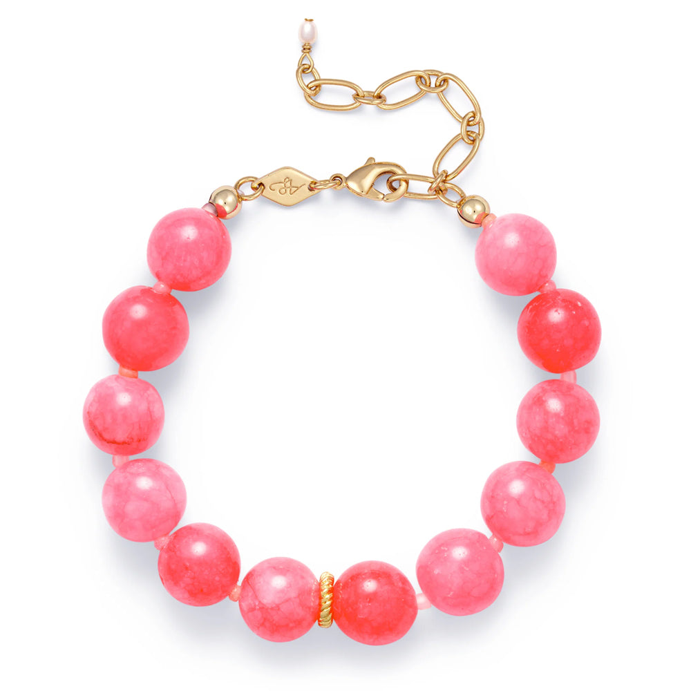 Pink beaded bracelet with gold clasp on a white background