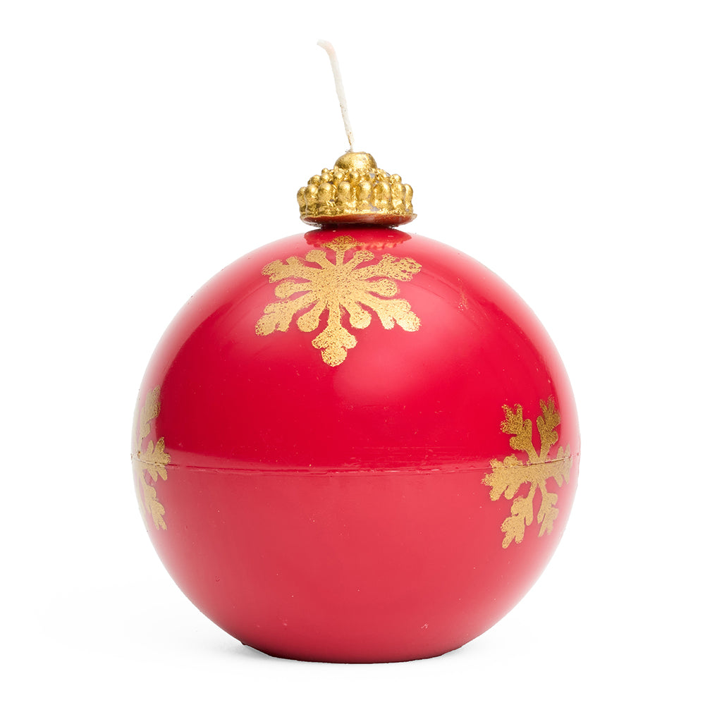 A 3d bauble shaped candle in red with gold snowflake pattern and gold topper with a wick.