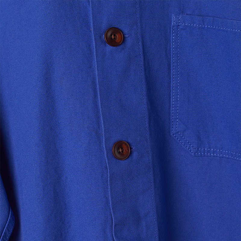 Image: close up of the brown buttons on the ultra blue buttoned overshirt.