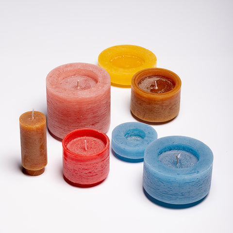 A seven-tiered stackable candle, unstacked, showing each candle individually.