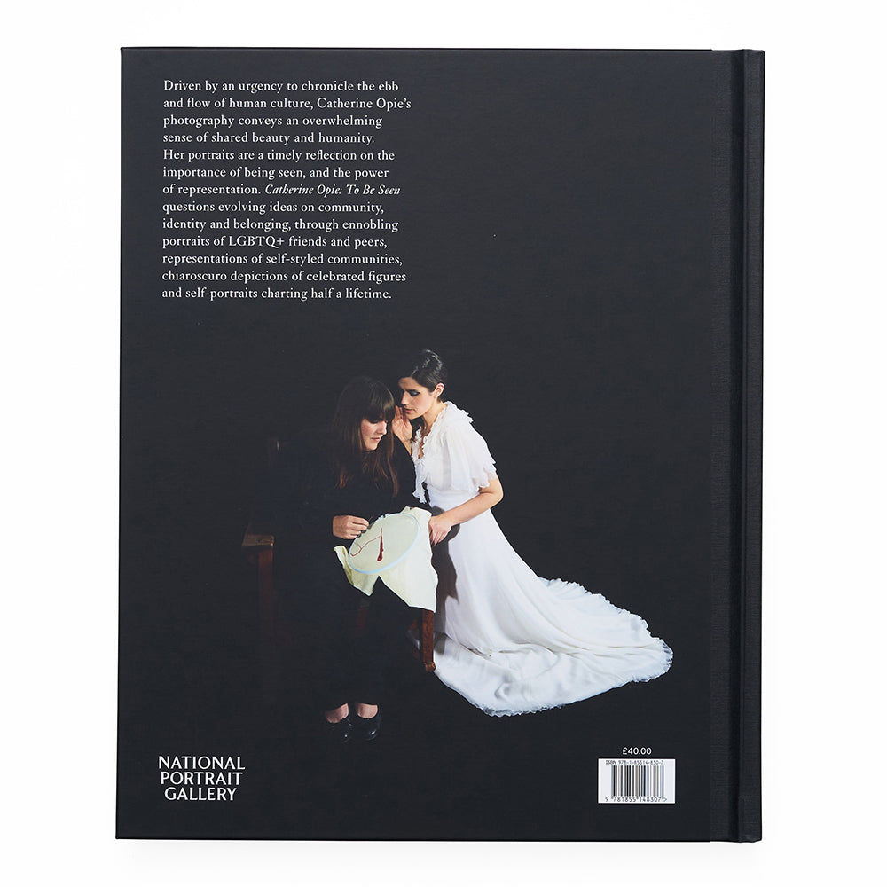 Back book cover with text and image of two women, one in a white dress, on a black background.