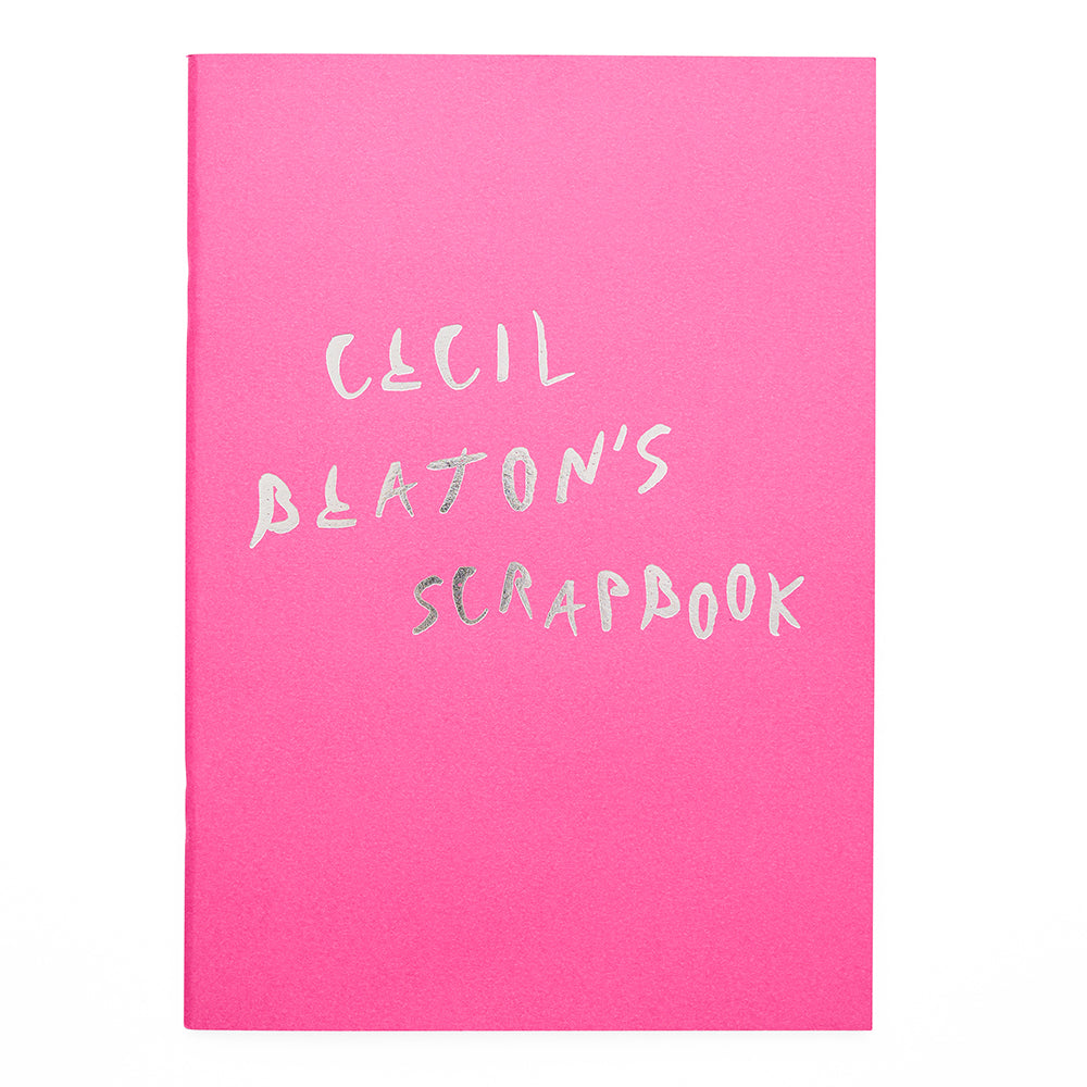 A4 rectangular scrapbook in pink with the worlds 'cecil beaton's scrapbook' in silver foil in a handwritten style
