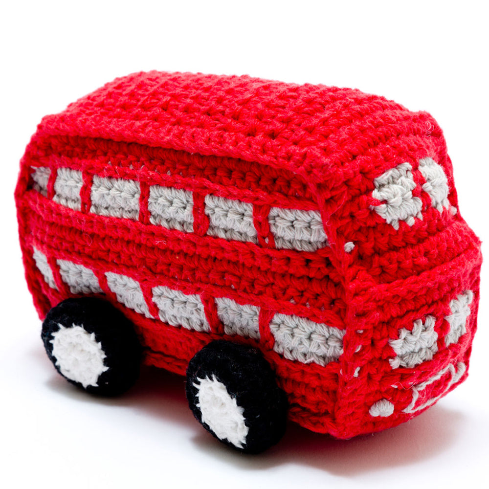 Crocheted red double decker bus rattle toy on a white background