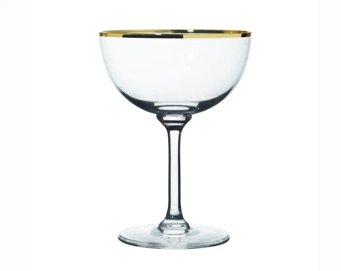 A glass champagne coupe glass with a gold rim.