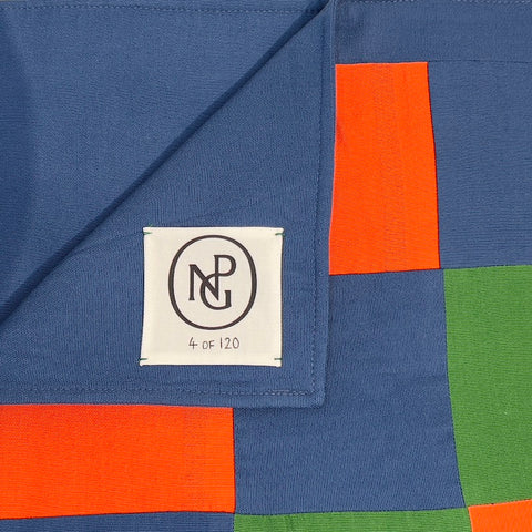 Close up detail of the NPG logo on the orange and green chequered table runner.