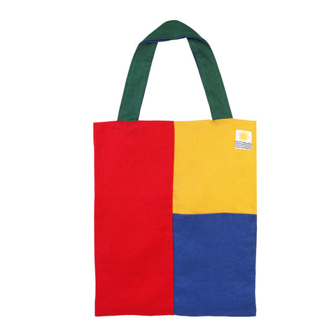 Red, yellow and blue squared tote bag with dark green handles.