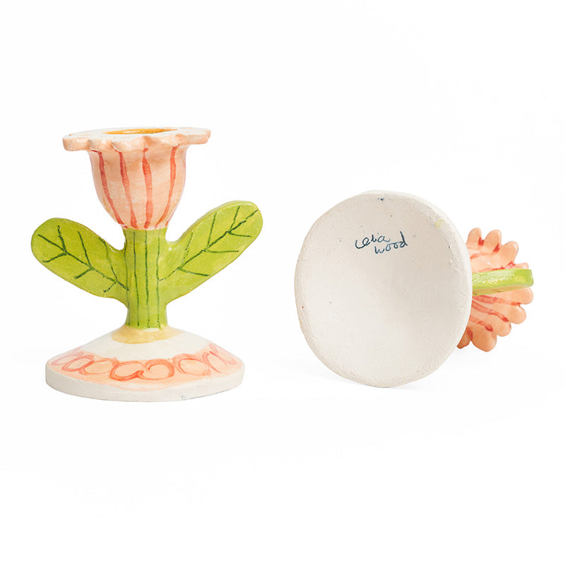 A pair of tulip flower shaped ceramic candlestick holders with 'celia wood' signed on the base.