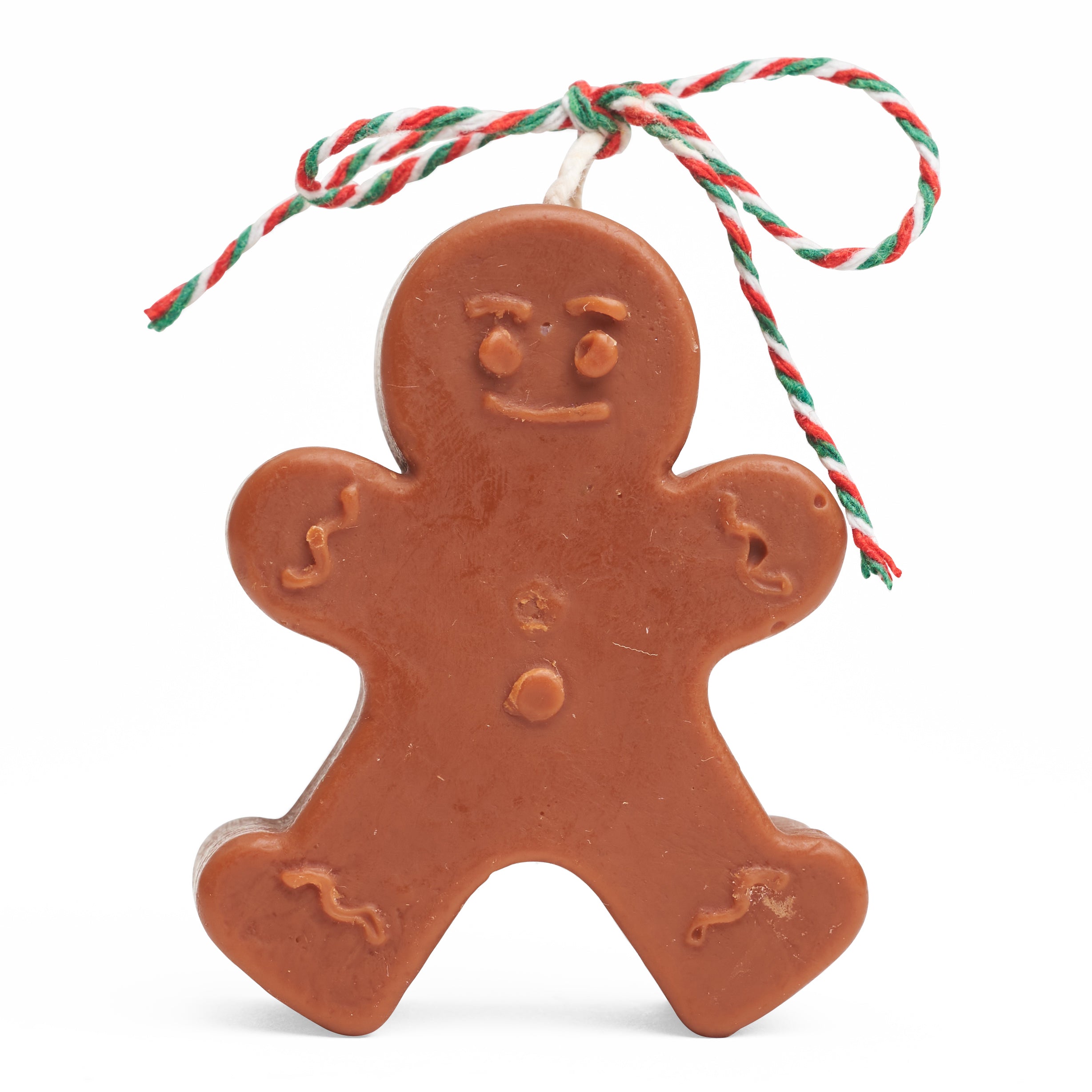 A dark brown gingerbread man candle with a candy coloured ribbon on the wick.