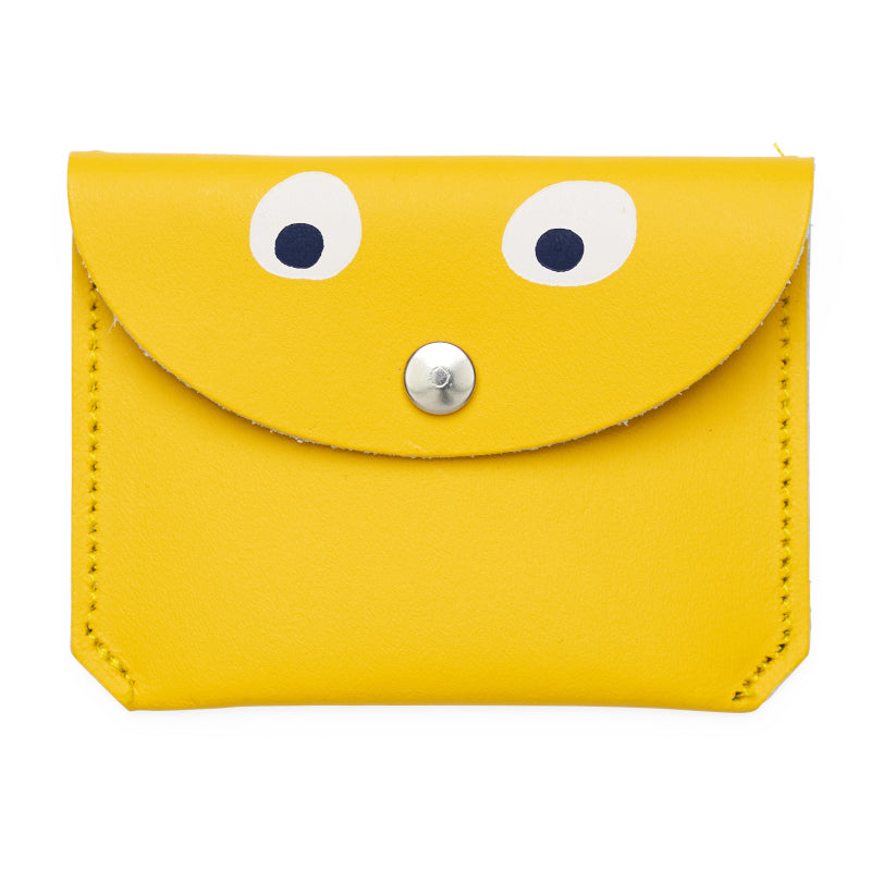 Mini yellow purse with popper close featuring a printed googly eye design.