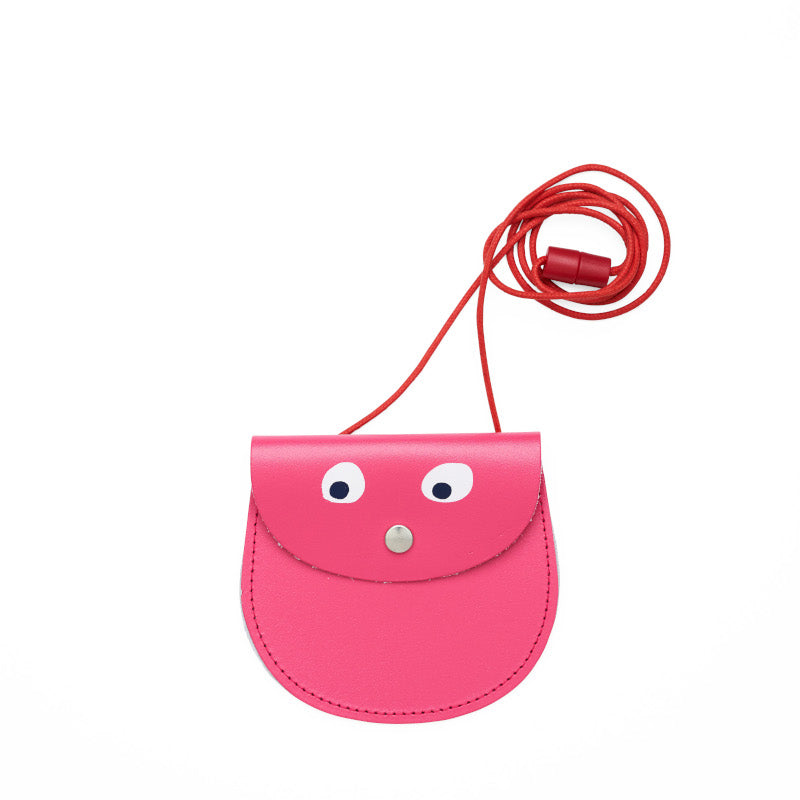Pink pocket purse with red strap featuring printed googly eye design .