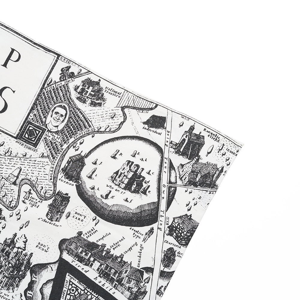 Close up detail of tea towel with black and white map illustration against a white background.