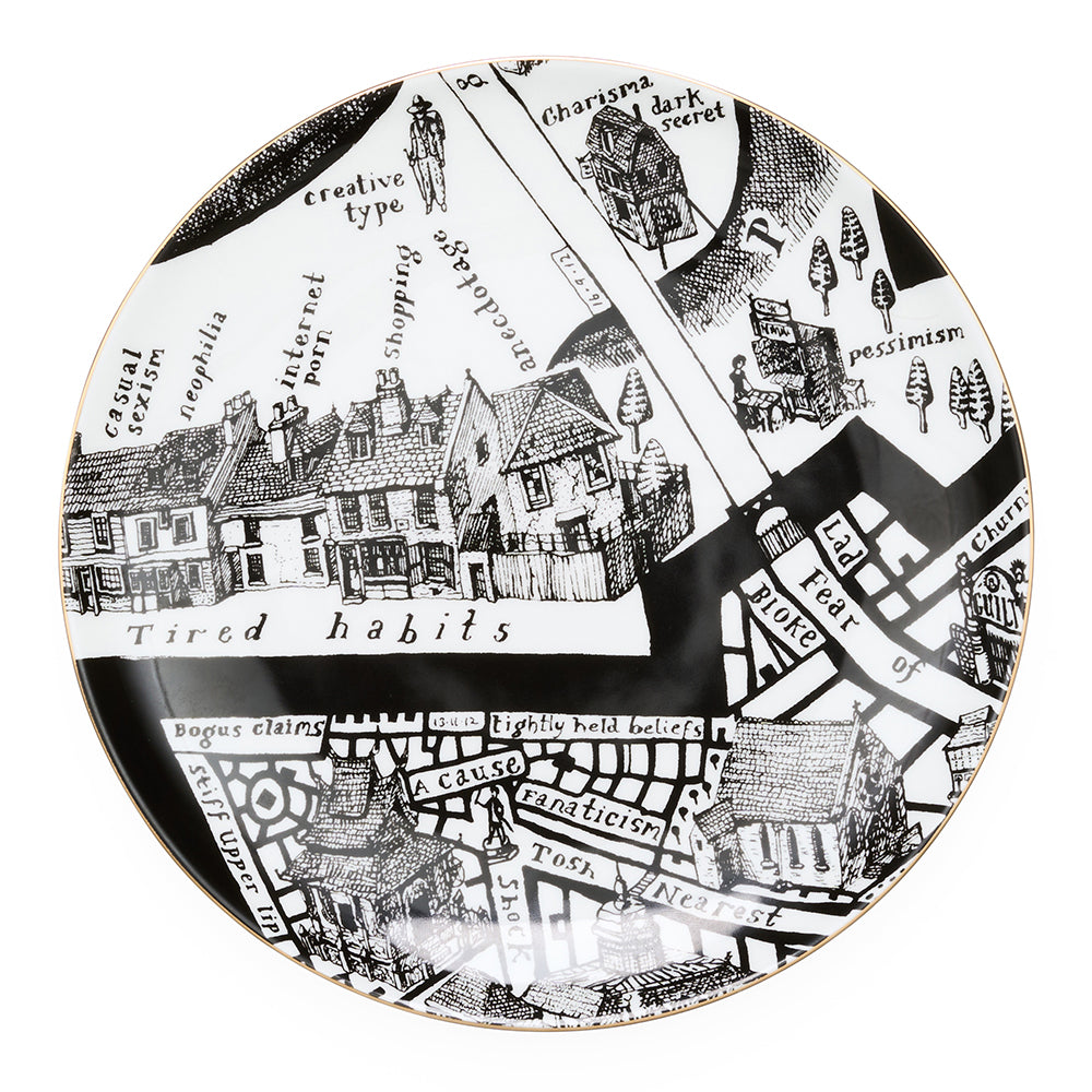 Decorative plate with black and white map design and gold rim on a white background
