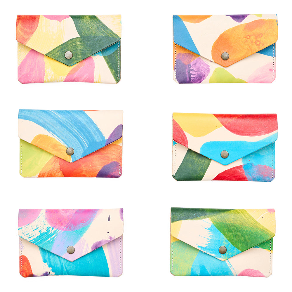 Set of six colourful card holders with abstract patterns on a white background