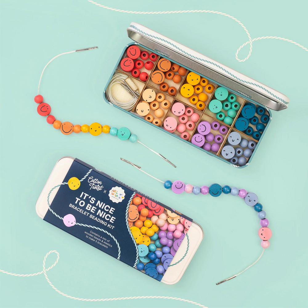 Colourful beading kit with beads and packaging on a light blue background