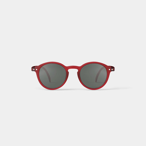 A pair of round kid's sunglasses with a red frame.