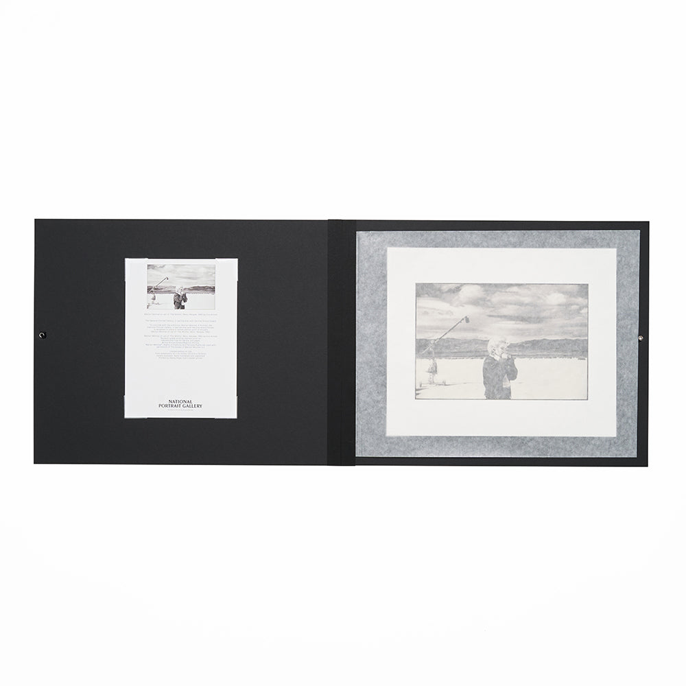 Open black folio with certificate of authenticity and a black and white photo print.