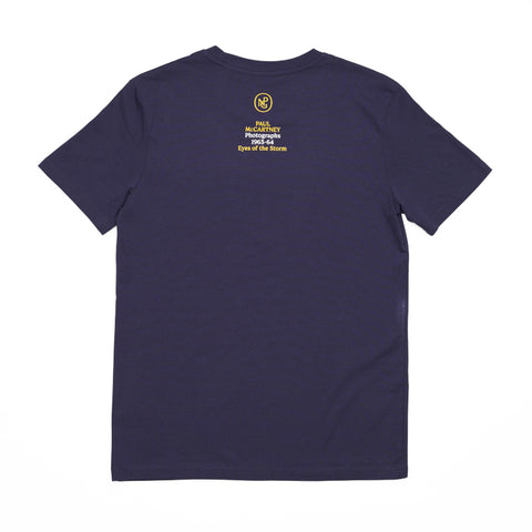 Reverse of the purple T-shirt featuring the exhibition title 'Paul McCartney Photographs 1963-64' and the National Portrait Gallery logo.