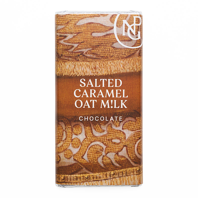 Rectangular chocolate bar packaged in an npg branded sleeve with close up detailing of textured gold fabric.