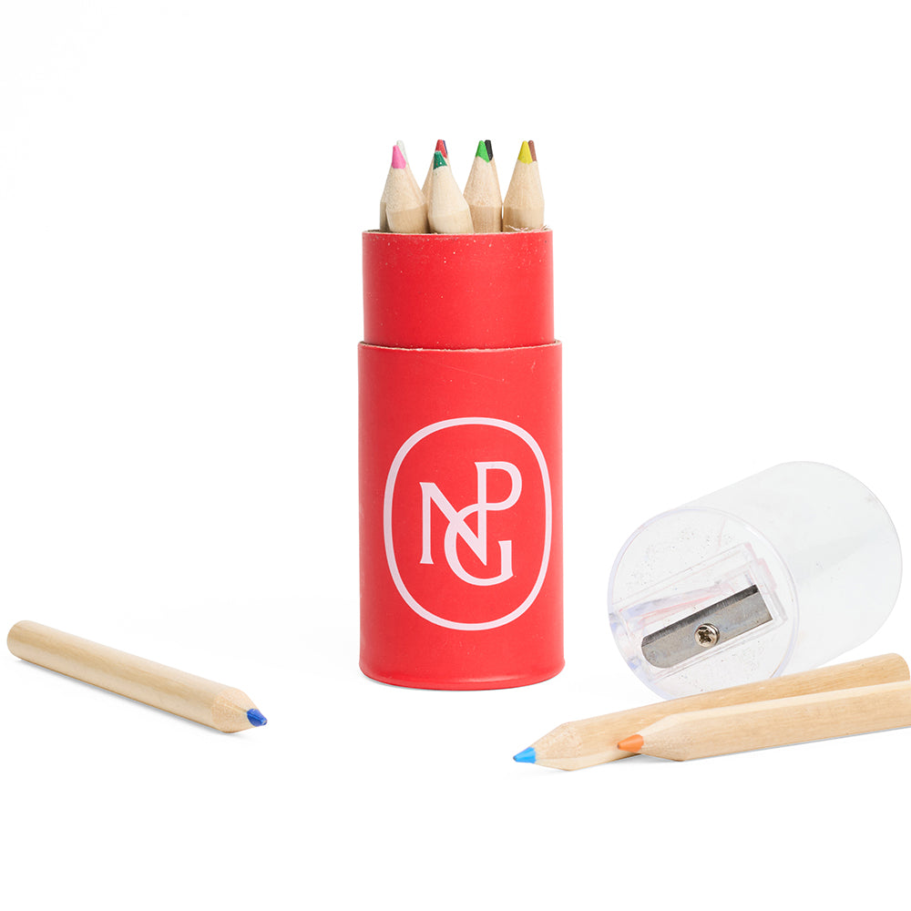 Set of coloured pencils in a red tube holder with a sharpener on a white background