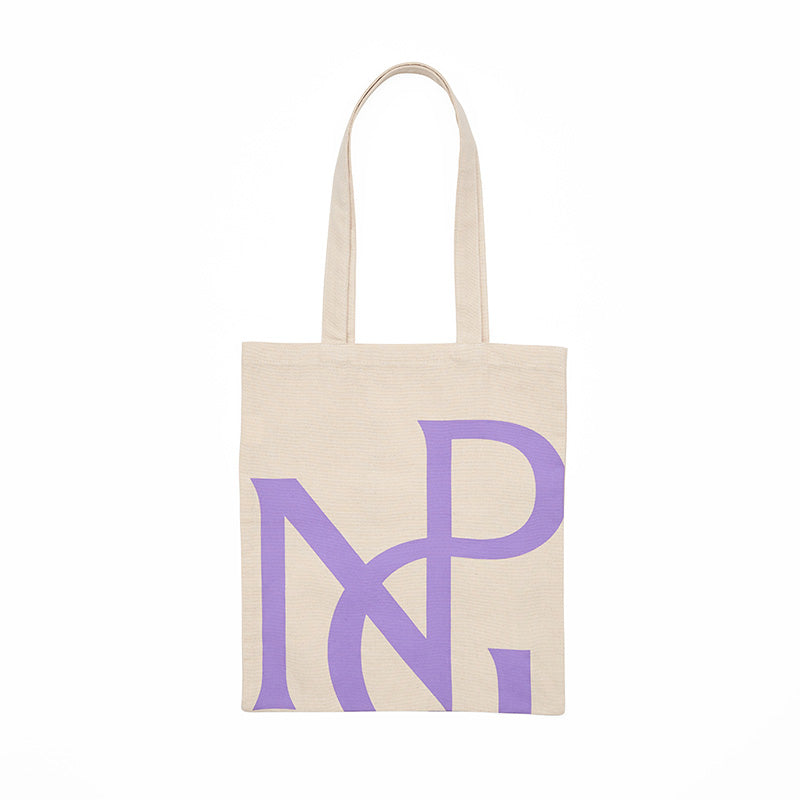 A cream tote bag with handles featuring a large npg monogram design in purple.