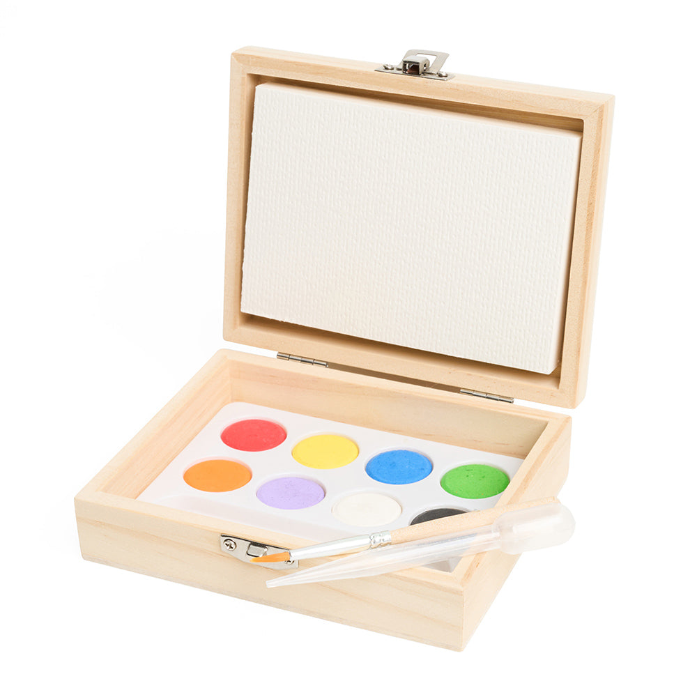 An open wooden box with a paint palette and paper inside.