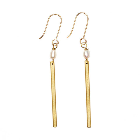 A pair of gold hoop earrings with a single pearl and gold bar hanging from each below. 