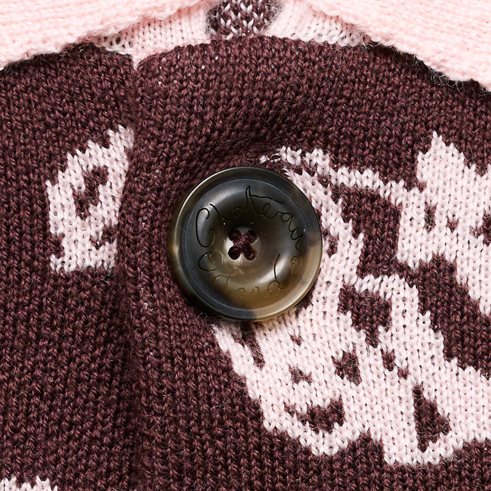 Close up of a button on a knitted fabric with a floral pattern