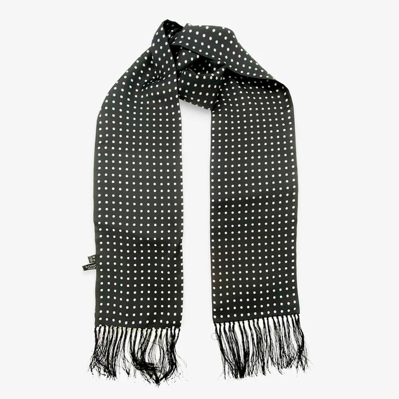 A long black scarf with tassels on the end with white polka dots.