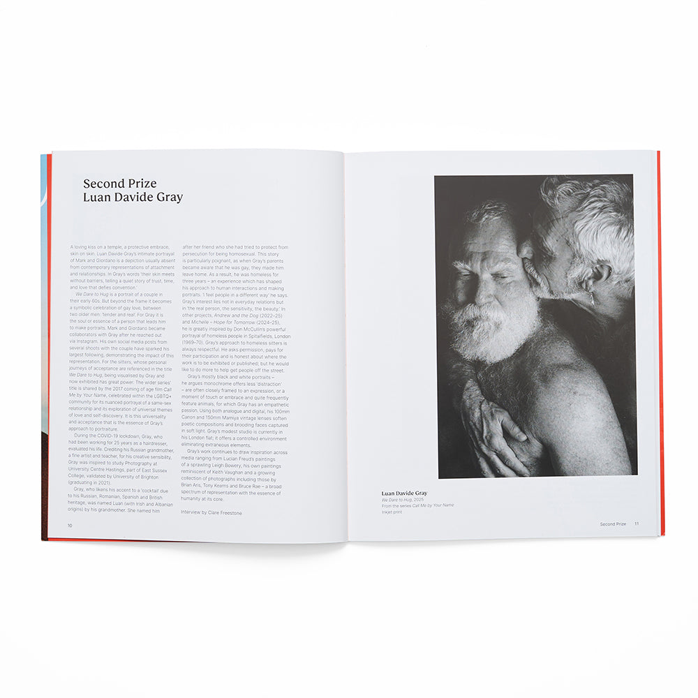 Open book showing a black and white photo of two people embracing and text on a white background