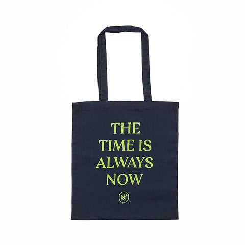 Navy tote bag with handles featuring 'The Time is Always Now' in green text.