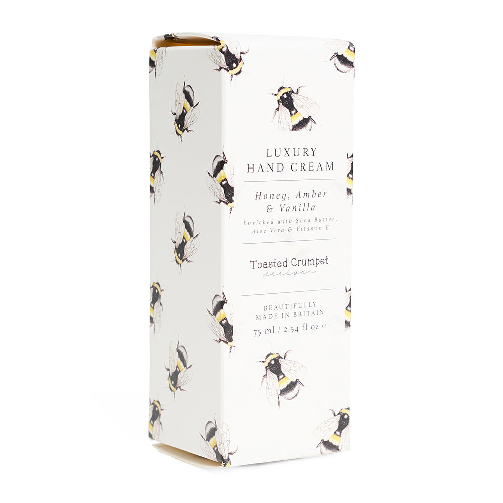 Box of luxury hand cream with bee design on a white background