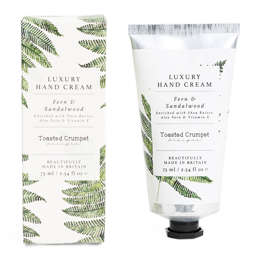Luxury hand cream with packaging featuring fern design on a white background