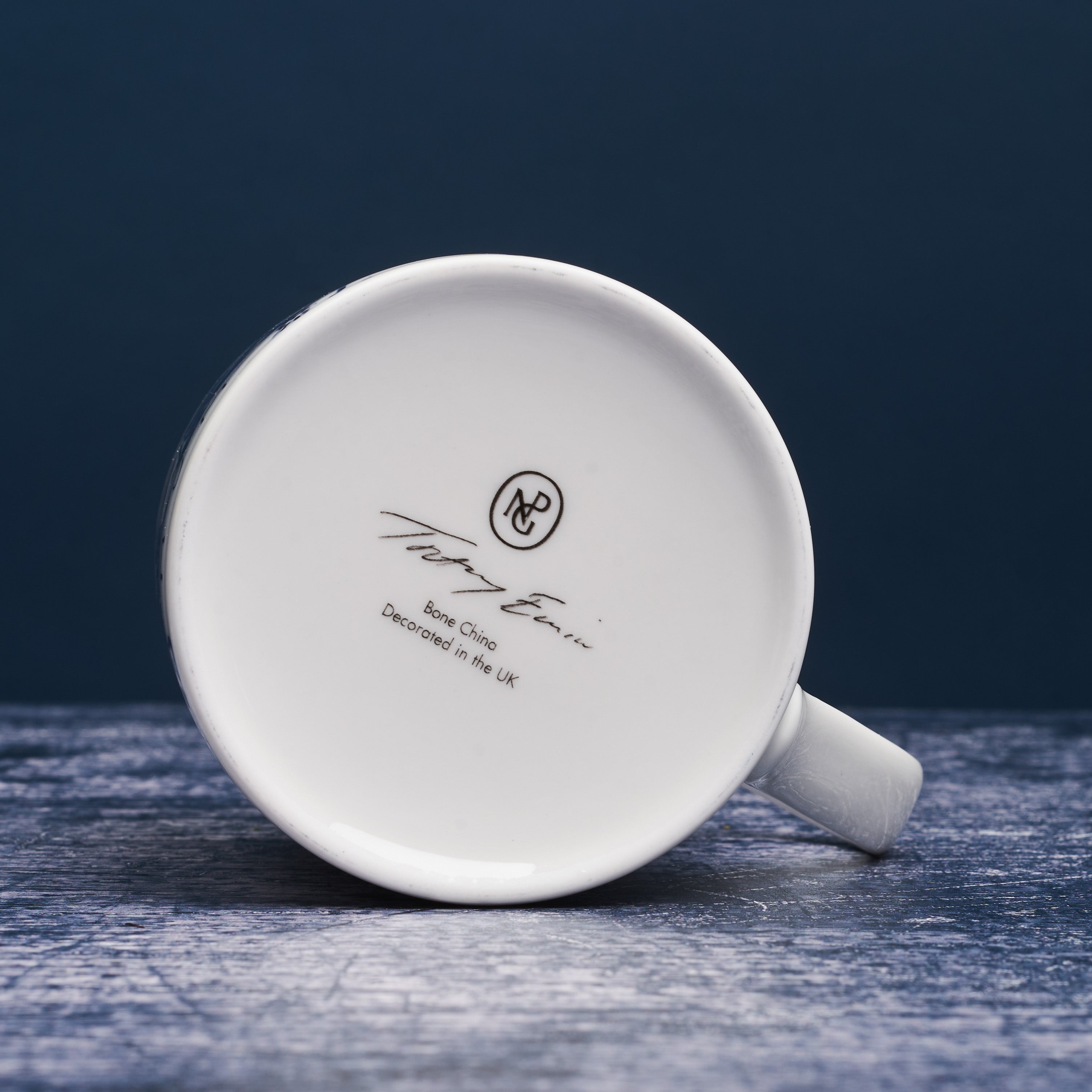 Bottom of white ceramic mug with tracey emin signature and npg logo.