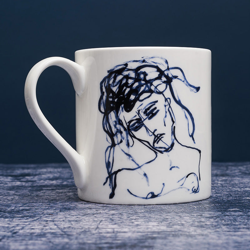 White ceramic mug with dark blue ink line illustration of a woman.