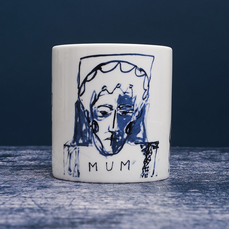 White ceramic mug with dark blue ink design of a woman with "mum" inscribed below the portrait.