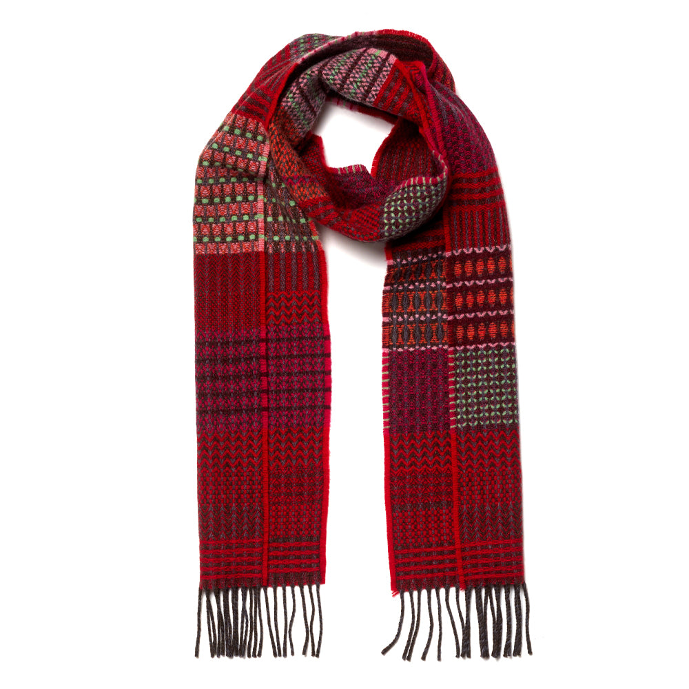 A red and dark gray patterned knit scarf with fringe ends, displayed against a solid white background.