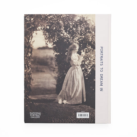 Reverse cover featuring a sepia tone photograph of a girl in a dress looking at roses in a garden.