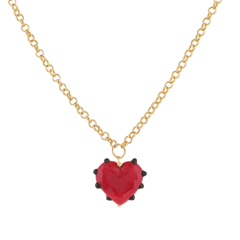 Red glass shaped bead surrounded by black dots on a gold chain necklace.