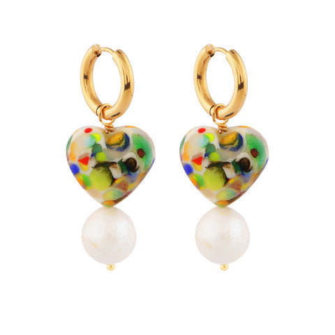A small gold hoop with a multicoloured glass heart pendant and pearl below.