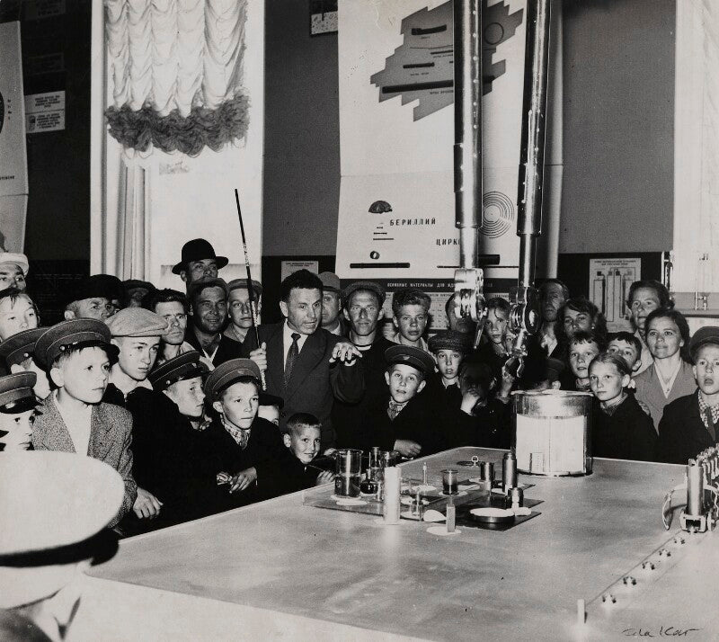 'several children watch a demonstration on how to handle radioactive material' npg x135220