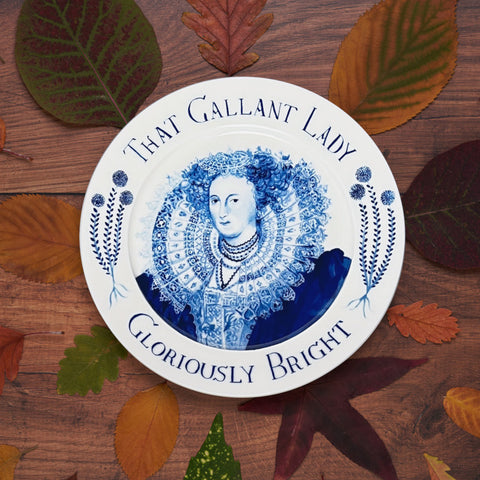 Mary Sidney Herbert ceramic plate by Pollyanna Johnson against a backdrop of autumn leaves.