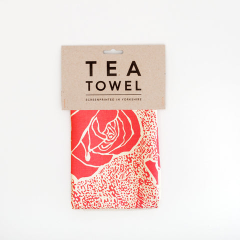 Tea towel with a pink rose design.
