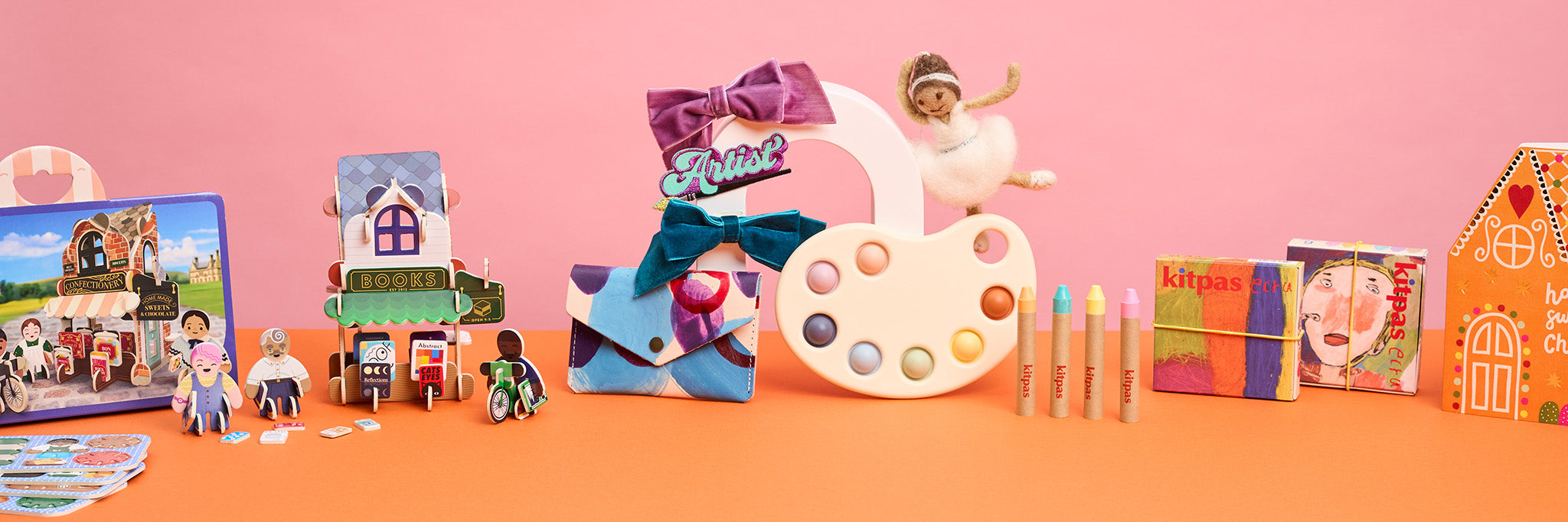 A selection of colourful purses with googly eyes displayed in a wave shape.