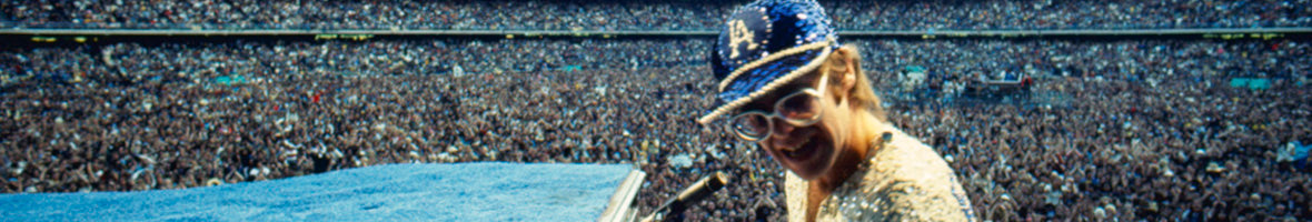 Photograph of elton john playing a stadium concert taken by terry o'neill