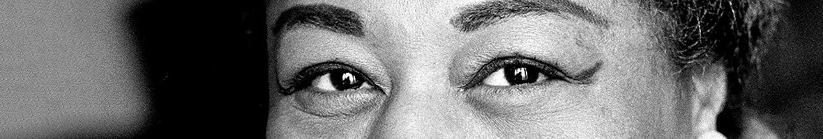 Black and white photograph of a woman's eyes with winged black liner. 