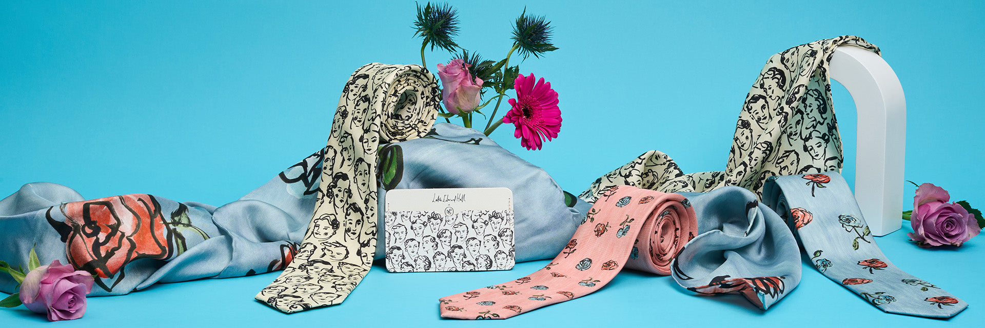 Image: a selection of gold and black necklaces, bags and hairclips styled against a plain white background.